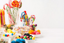 Different Colorful Candy Sweets. Mix Candy Confectionery In Jars On White Wooden Background With Copy Space