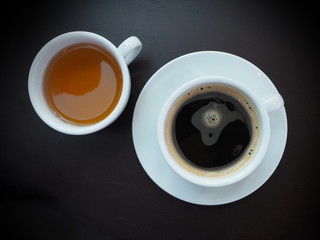 Black coffee in a white mug on a dark background