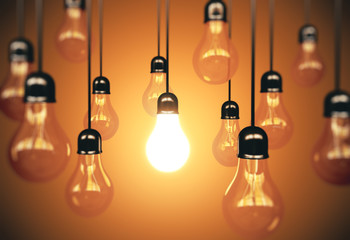 Poster - Many light bulbs and one glows