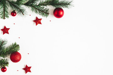 christmas composition. fir tree branches, red decorations on white background. christmas, winter, ne