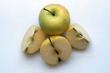 Organic yellow apple  and half sliced apple on white background