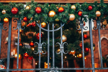 Christmas decoration lies on the forged railing.