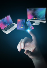 Poster - Businessman connecting modern smartphone tablet laptop and computer 3D rendering