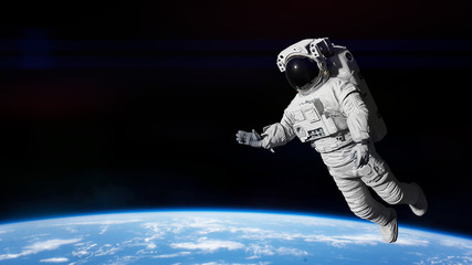 Wall Mural - astronaut performing a spacewalk in outer space