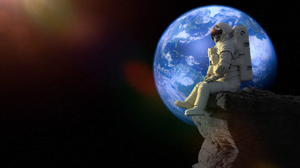 Wall Mural - astronaut sitting on a cliff on the moon in front of planet earth