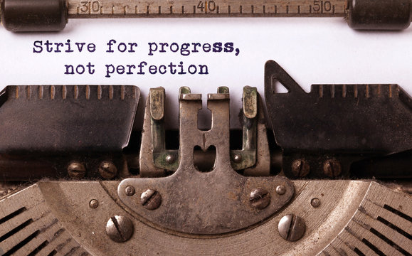 Strive for progress, not perfection - Written on an old typewriter