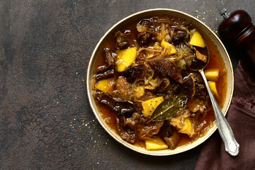 traditional russian sour cabbage soup ( shchi ) with dried mushroom. top view with copy space.