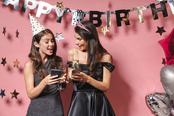 Sticker - Women friends using mobile phones drinking champagne.