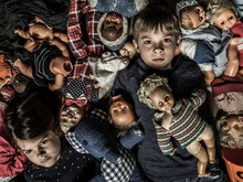 Scary Children In A Pile Of Creepy Dolls