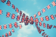 British Union Jack Flag Bunting Strung Across Soft Blue Sky 