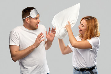 Poster - relationships and people concept - couple in white t-shirts with eye sleeping mask and pillow over grey background