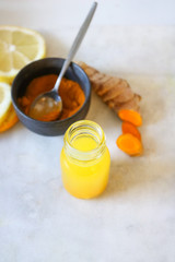 Wall Mural - Close up of Turmeric (curcuma) shot on a marble board