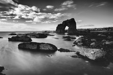Grayscale Shot Of The Thurlestone Rock In Devon, UK