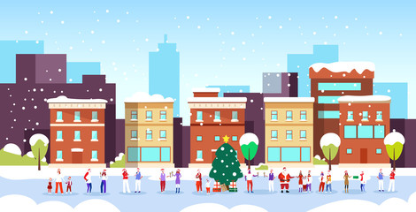 Wall Mural - people celebrating merry christmas happy new year winter holidays concept men women wearing santa hats standing near fir tree modern city street cityscape background full length horizontal vector