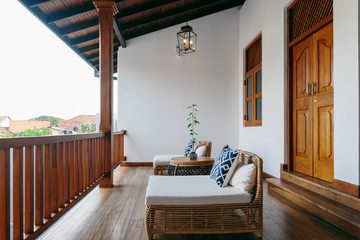 Balcony with armchairs and wooden floor in luxury asian hotel