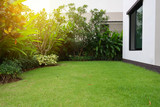 Fototapeta Kamienie - lawn landscaping with green grass turf in garden home