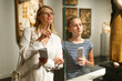 © JackF - Girl with woman pointing to exhibits and looking with interest  in museum