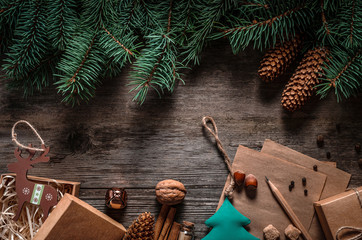 Wall Mural - Christmas green frame from fir branches on a vintage gray board background. Frame of fir branches. Christmas card blank.