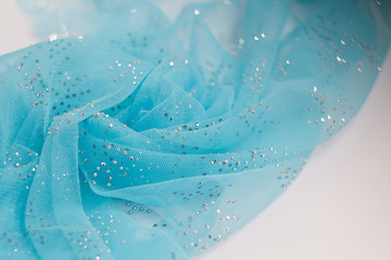 Texture, background, pattern. Blue ribbon in a small grid. Wide blue tulle gauze mesh fabric embroidered ribbon ribbon lace trim blurred background