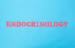 The word endocrinology on a blue background. The concept of the section of medicine dealing with the treatment of diseases of the thyroid gland and endocrine system