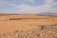 Passenger Train In Wide Desert Landscape