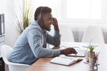 Poster - Cheerful manager wearing headset and using laptop, speaking with client
