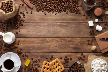 Wall Mural - cup of coffee and beans on wooden background