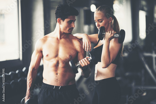 Cuadros en Lienzo Fitness couple - woman and man in sport gym