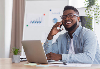 Poster - Happy black businessman talking on phone, receiving good news