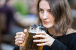 © enginakyurt - portrait of young woman drinking beer at the bar