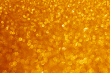 Wall Mural - New Year,Xmas Golden abstract sparkles or glitter lights.2020.Defocused circles bokeh or particles.Template for design.Blurred golden holiday abstract glitter defocused background with blinking stars.