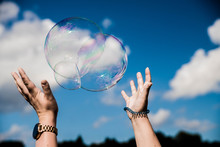 Globe In Hand, Soap Bubble In Hand. Catching Soap Bubbles