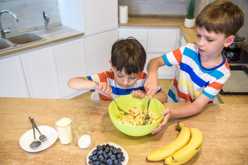 happy family funny kids are preparing the dough, bake cookies in the kitchen