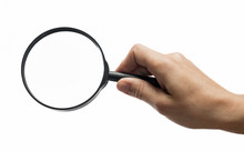 Female Hand Holding The Magnifying Glass On Isolated White Background.