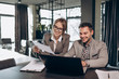 © Kuz Production - Male and female business partners working in office by a laptop