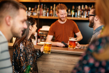 Poster - Group of friends drinking beer, chatting and having good time at pub. Night out.