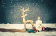 burning candle from 2 nd advent in front of vintage background and decorative christmas background in snow