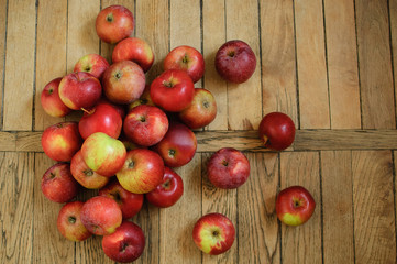 Top view of ripe red juicy apples on wooden background, healthy eating concept, copy space