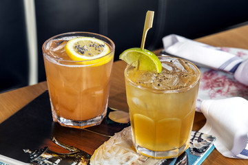 Two lime and lemon fresh alcohol cocktail at a restaurant interior 