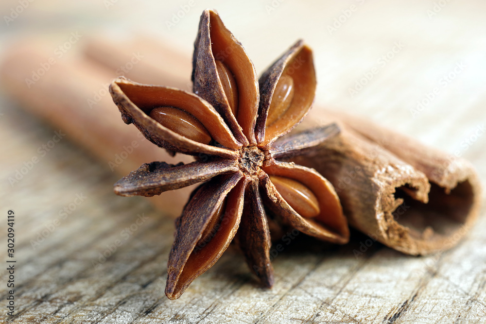 anise star and cinnamon on a wooden table close up. - obrazy, fototapety, plakaty 