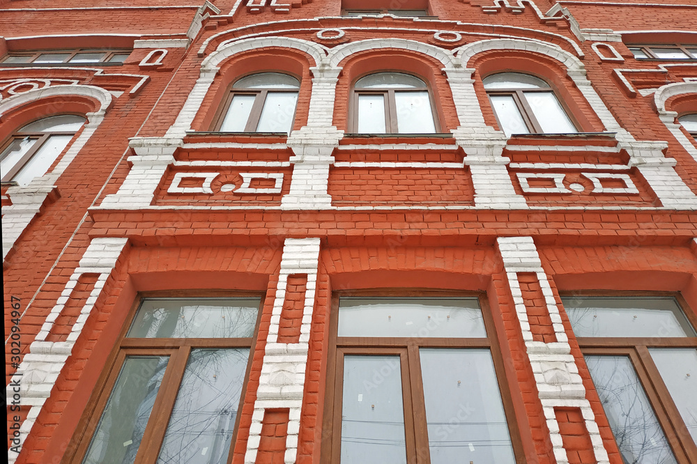 Beautiful red brick building with white trim. Facade of an old house ...