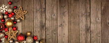 Red And Gold Christmas Ornament Corner Border Banner. Above View On A Rustic Wood Background.