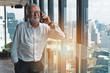 © Mongkolchon - business background of senior top executive having business talk with smartphone in office