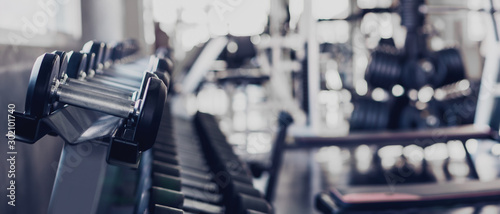 Cuadros en Lienzo gym interior background of dumbbells on rack in fitness and workout room