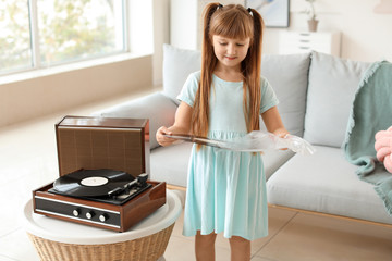 Sticker - Cute little girl listening to music through record player at home