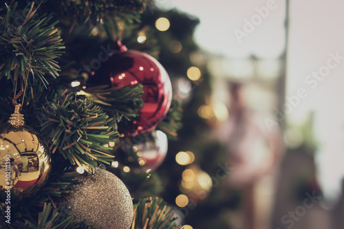 Fotomural bauble hanging from a decorated Christmas tree