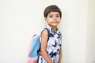 Wall Mural - Cute indian child girl with Holding school bag