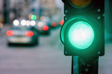 A city crossing with a semaphore. Green light in semaphore