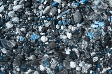 light blue brilliant sea stones wet by waves texture - nice abstract photo background