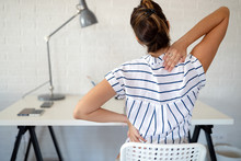 Overworked Woman With Back Pain In Office With Bad Posture